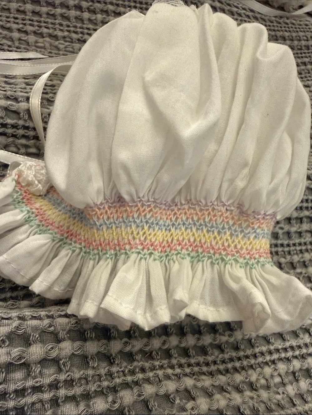 White Smocked Baby Bonnet with Pastel Rainbow Stitching